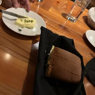 a table with a sandwich and butter