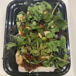 a salad in a styrofoam container