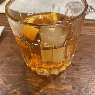 a glass of whiskey with ice cubes