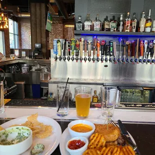 Grilled cheese with prime rib, spinach and artichoke dip, bar area with taps.