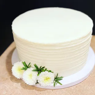 a white cake with flowers