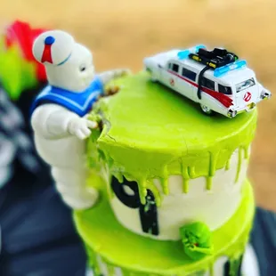 a cake with a ghost and a car on top