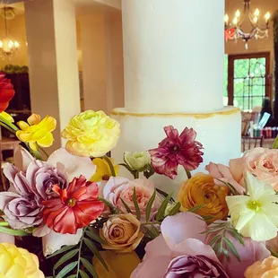 a wedding cake surrounded by flowers
