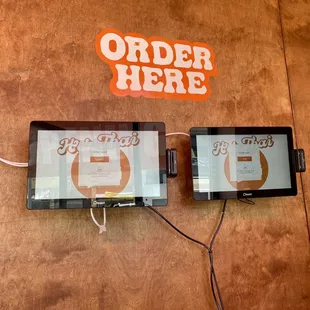 two tablets connected to a wall