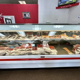 Display case of hotdogs, etc.