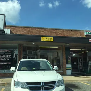 a white car parked in front of a store