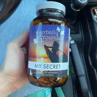 a hand holding a jar of my secret