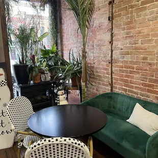 a living room with a green couch and a black table