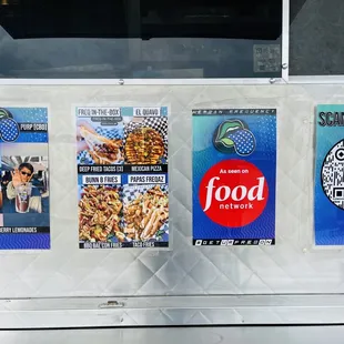 a food truck with posters on it