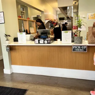 a woman standing in front of a counter