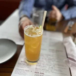 a man sitting at a table with a drink