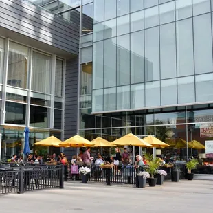 the outside of a restaurant with yellow umbrellas