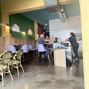 people sitting at tables in a restaurant