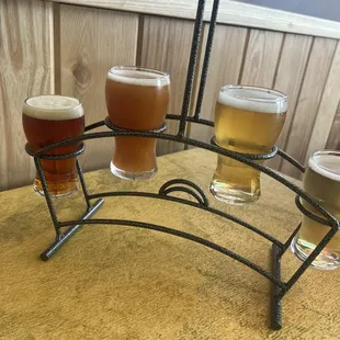 four glasses of beer on a table