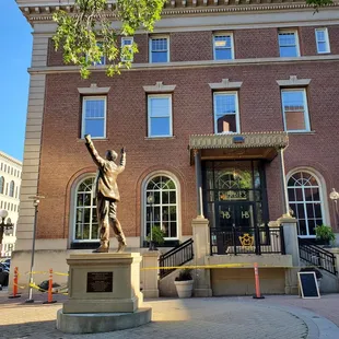 a statue in front of a building