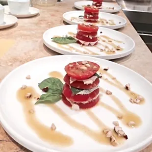 Tomato-stack salads with chevre style cashew cheese, fresh basil, toasted nuts and a balsamic vinaigrette.