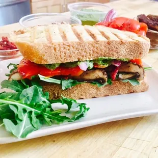 Mediterranean Sandwich with Sherry Roasted Mushroom, Red Bell Pepper, Almond-Kalamata Cheese Spread, Pesto and Red Onion.
