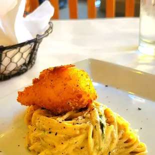 Guanciale and fried poached egg over spaghetti.