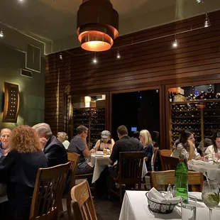 a large group of people sitting at a table in a restaurant