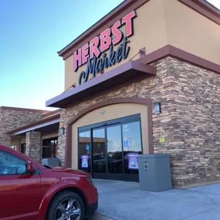 a red truck parked in front of the store