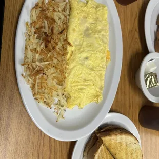 Bacon, Cheddar and Provolone Omelette with hash browns and sourdough toast.