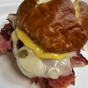 Pastrami Slider with muenster cheese, mustard sauce on a pretzel roll