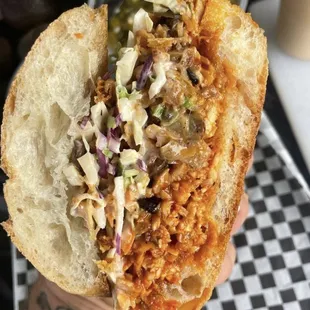 a person holding a sandwich