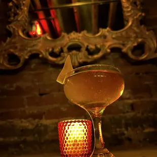 a glass of wine and a candle