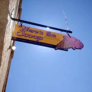 a sign hanging from the side of a building