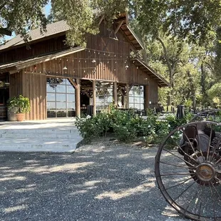 a horse drawn carriage in front of a barn