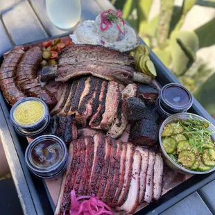 Beef rib, Philly cheesesteak links, brisket, char siu pork belly, burnt ends, potato salad, spicy cucumber.