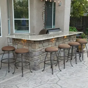 BBQ island and concrete pool deck installed by Heritage Bomanite.