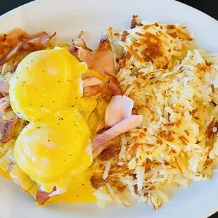 a plate of eggs, hash browns, and hash browns