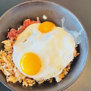 fried eggs and hash browns in a bowl