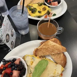a breakfast of eggs, toast and fruit