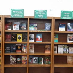 a display of books on wooden shelves