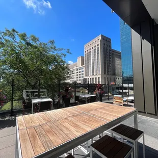 a view of the city from a rooftop patio