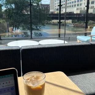 a cup of coffee and a pen on a table