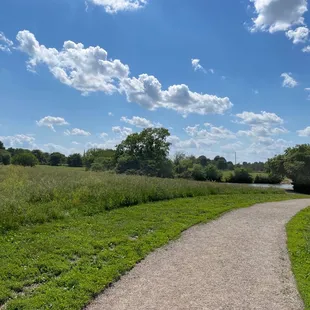Wide smooth path, open grassy areas.