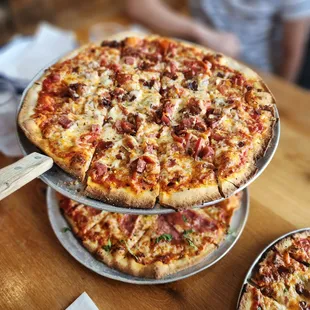 three pizzas on a table