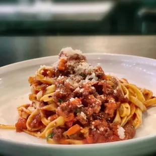 Prime Beef Bolognese $28 /house made tagliatelle,San Marzano tomato, garlic, chili flakes, parmigiana-reggiano, red &amp; port wine.