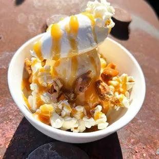 Grilled corn cob and popcorn demifreddo, caramel sauce, toffee peanuts, popcorn &amp; whipped cream.