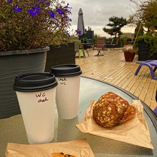 two coffee cups and a pastry on a table