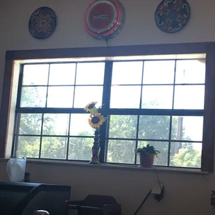 a table with a vase of flowers in front of a window