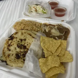 Two vegetarian papusas with rice, beans, and all the toppings. Tasty hot sauce too.