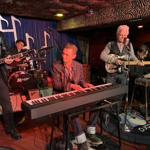 shows a band playing on a stage