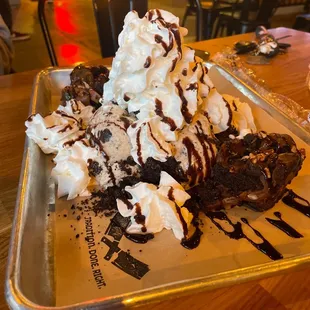a desert with whipped cream and chocolate sauce