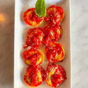 Spinach &amp; Ricotta Ravioli with a vibrant marinara sauce.