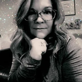 Laura E.