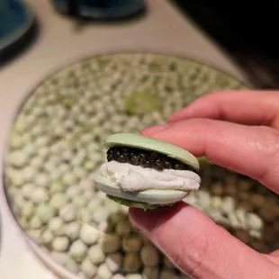 Pre-Course 1 of 4. English pea macarons with creme fraiche and Siberian caviar.